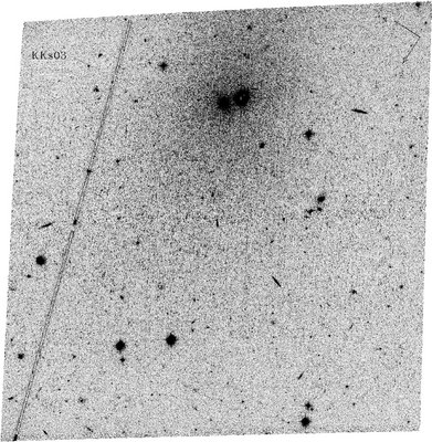 A negative image of KKs 3, made using the Advanced Camera for Surveys <br />on the Hubble Space Telescope. The core of the galaxy is the right hand <br />dark object at the top centre of the image, with its stars spreading out <br />over a large section around it. (The left hand of the two dark objects is <br />a much nearer globular star cluster.) Credit: D. Makarov