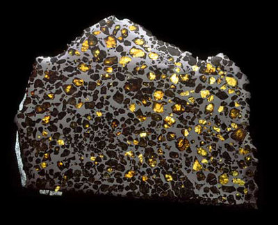 This Esquel pallasite from the Natural History Museum, consists of gem quality <br />crystals of the silicate mineral olivine embedded in a matrix of iron-nickel alloy. <br />Copyright: Natural History Museum, London