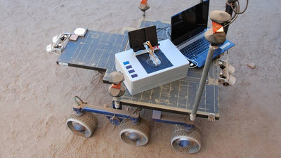 The Chemical Laptop, developed at JPL, analyzes liquid samples and detects <br />amino acids and fatty acids. These are both chemicals that are essential to <br />life. Researchers took the Chemical Laptop to JPL's Mars Yard, where they <br />placed the device on a test rover. This image shows the size comparison <br />between the Chemical Laptop and a regular laptop. Credit: NASA/JPL-Caltech