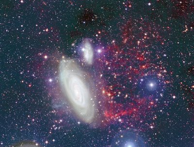 The foreground galaxy is NGC 4569 of the Virgo cluster. The red filaments <br />at the right of the galaxy show the hydrogen gas that has been removed. <br />The tail represents about 95 per cent of the gas reservoir the galaxy needs <br />to feed the formation of new stars. Credit: CFHT/Coelum