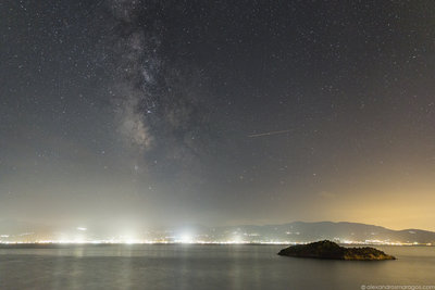The Milky Way over the cities of west Peloponnese in the Gulf of Corinth, Greece.