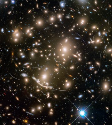Galaxy cluster Abell 370 contains several hundred galaxies tied together <br />by the mutual pull of gravity. It is located approximately 4 billion light <br />years away in the constellation Cetus, the Sea Monster. The thin, white <br />trails that look like curved or S-shaped streaks are from asteroids that <br />reside, on average, only about 160 million miles from Earth. The trails <br />appear in multiple Hubble exposures that have been combined into one <br />image. Of the 22 total asteroid sightings for this field, five are unique <br />objects. These asteroids are so faint that they were not previously <br />identified.  Credits: NASA, ESA, and STScI